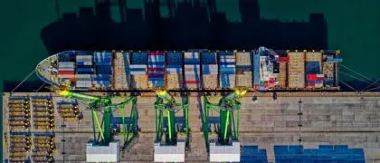 a ship at the dock with containers on it